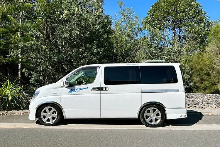Der Buddy Camper von Awesome Campers in Australien auf Straße vor Bäumen